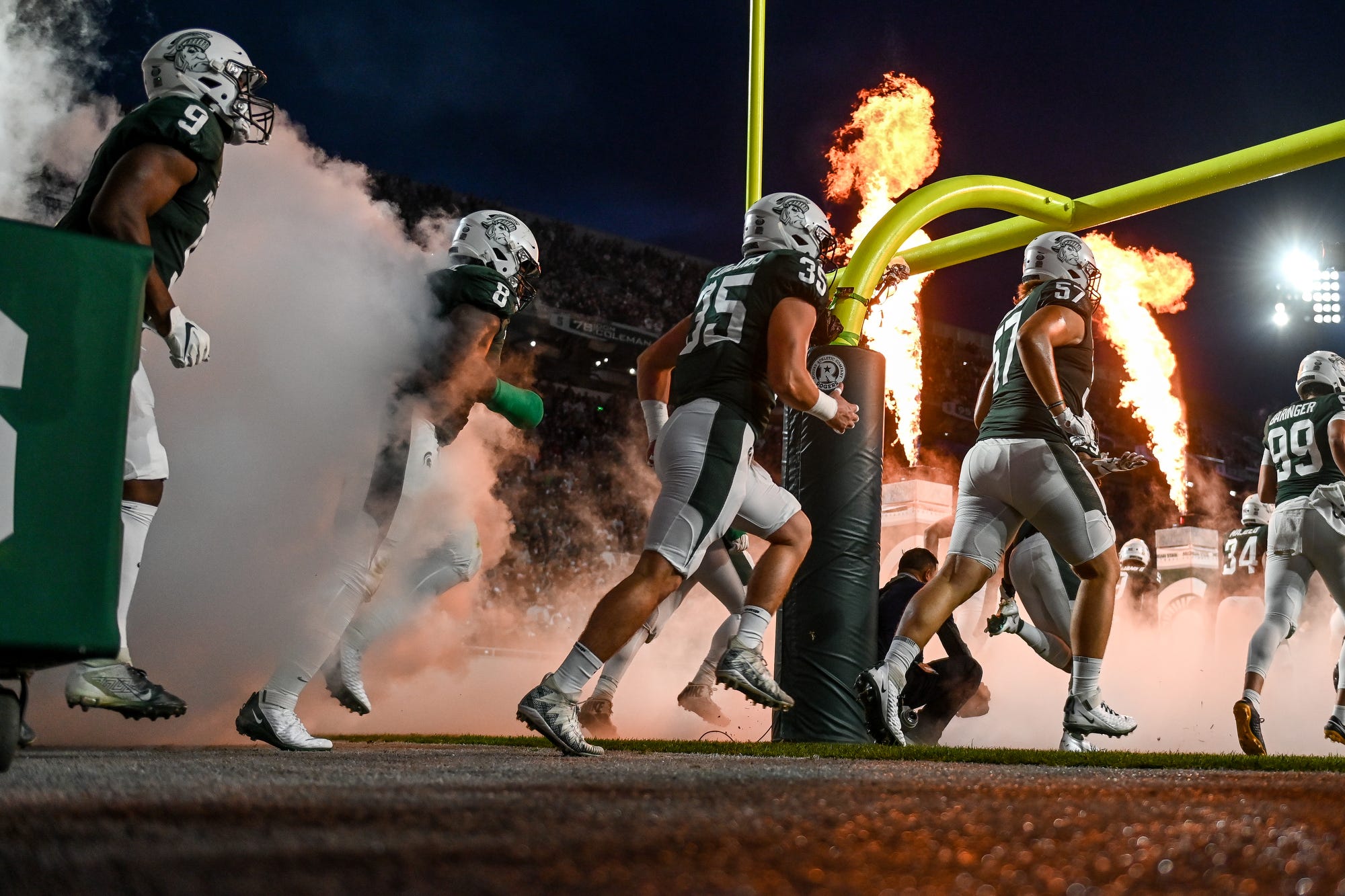 Michigan State Football team runs onto the field for a game against Western Kentucky at Spartan Stadium