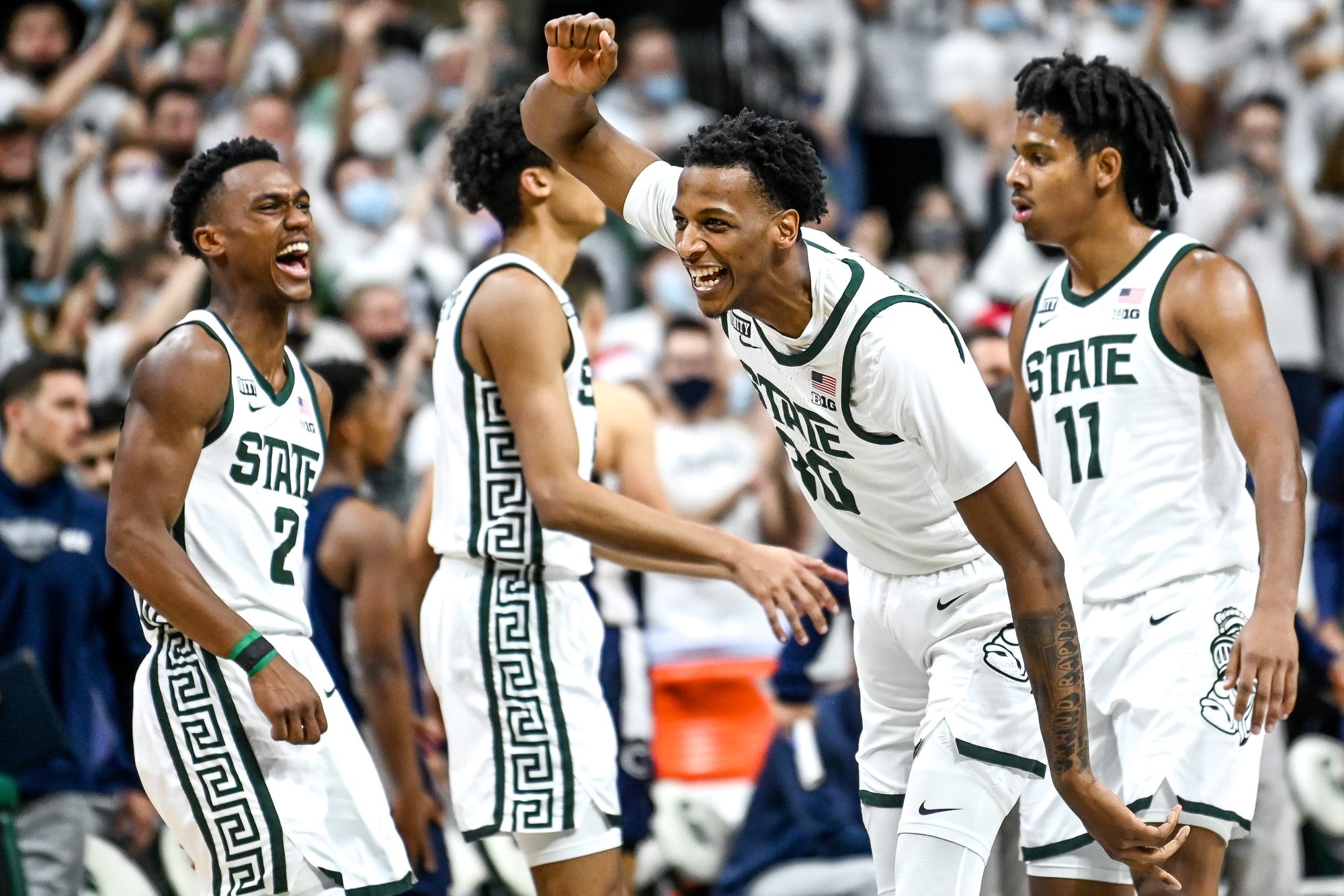 Michigan State basketball player Marcus Bingham Jr. celebrates with teammates in a game against Penn State