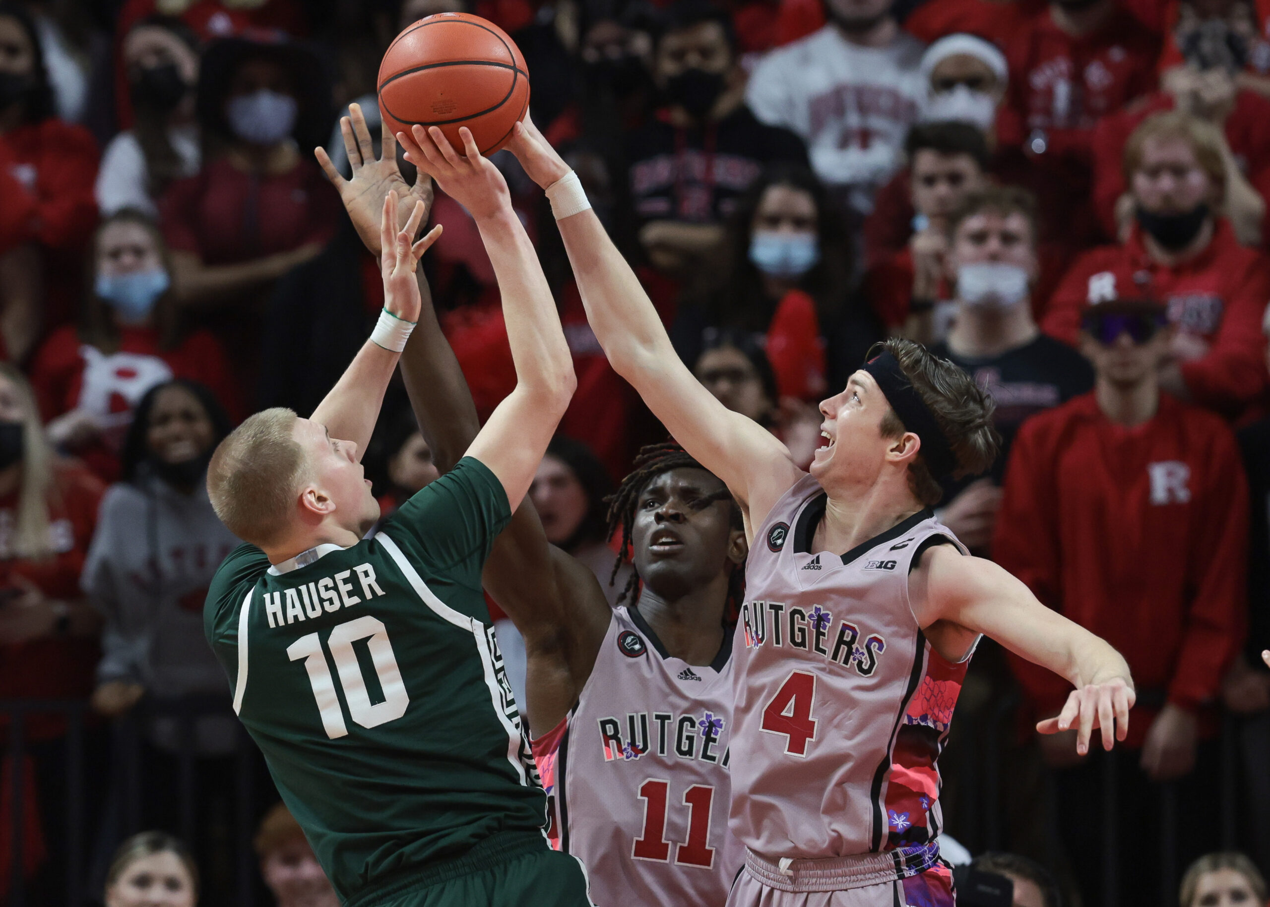 Michigan State basketball player Joey Hauser gets his shot blocked in a game against Rutgers