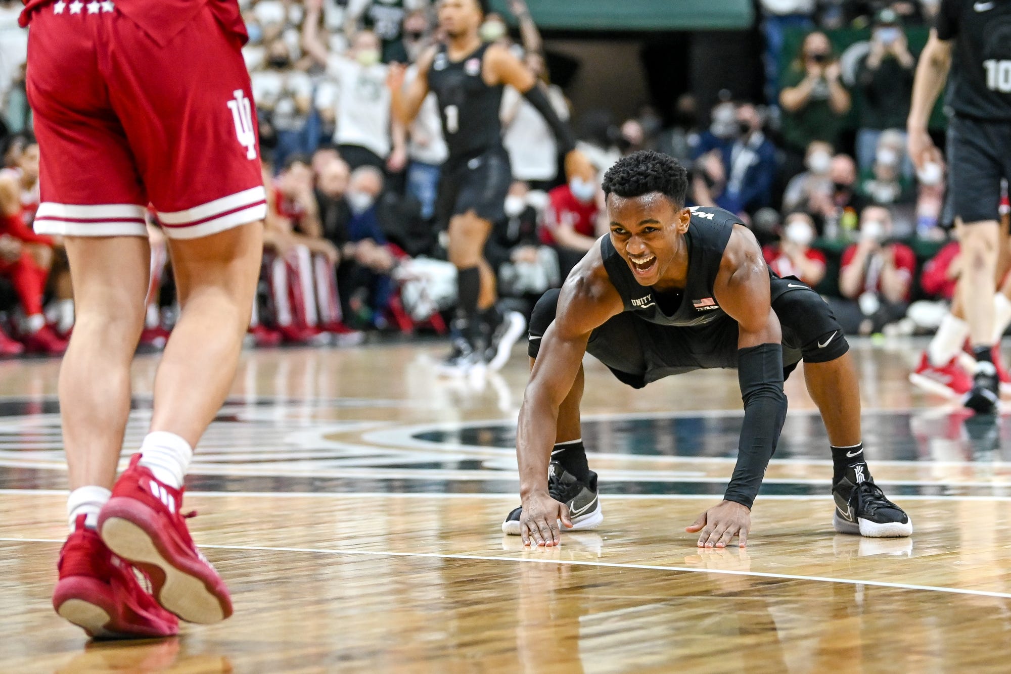 Michigan State Basketball Point guard Tyson Walker slaps the floor in a game against the Indiana Hoosiers