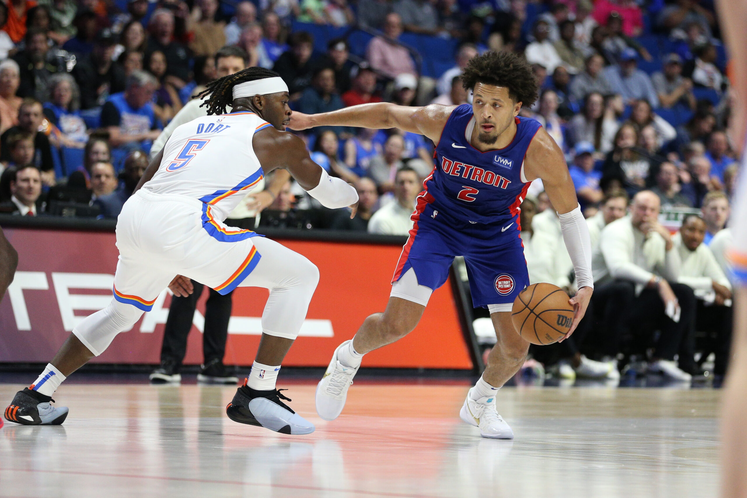 Oct 19, 2023; Tulsa, Oklahoma, USA; Detroit Pistons guard Cade Cunningham (2) attempts to drive around Oklahoma City Thunder guard Luguentz Dort (5) in the first half at BOK Center. Mandatory Credit: Joey Johnson-USA TODAY Sports. Article by Brandon Dent.